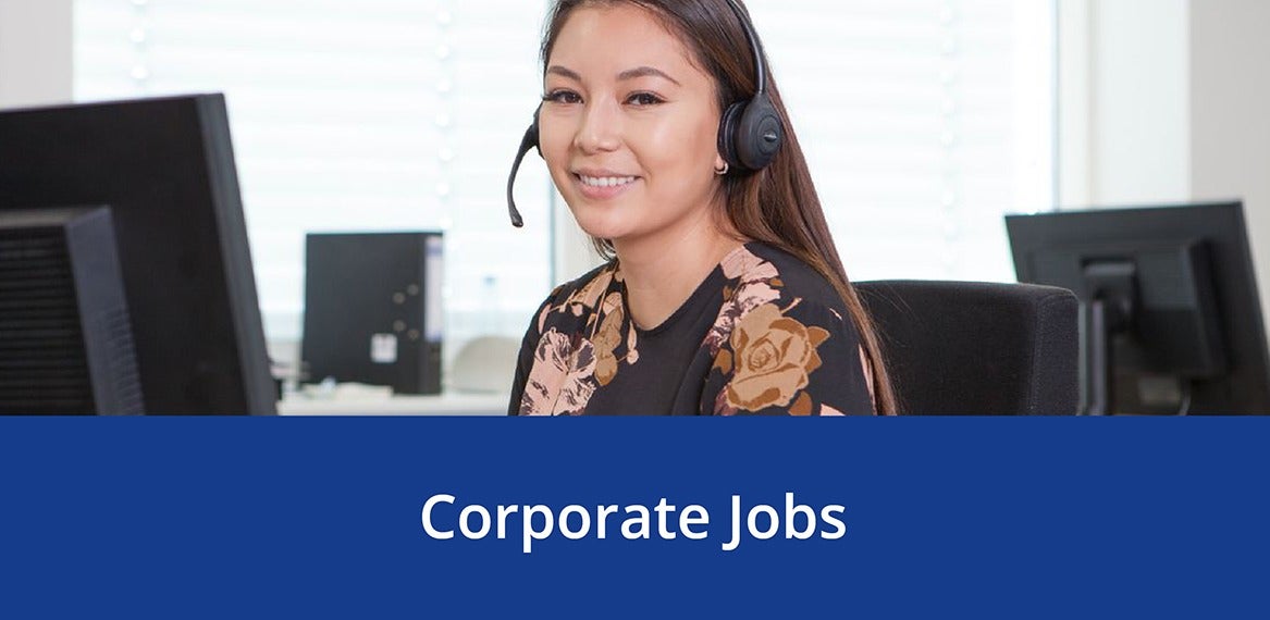 A smiling employee wearing a headset in a JYSK office above the words 'Corporate Jobs.'